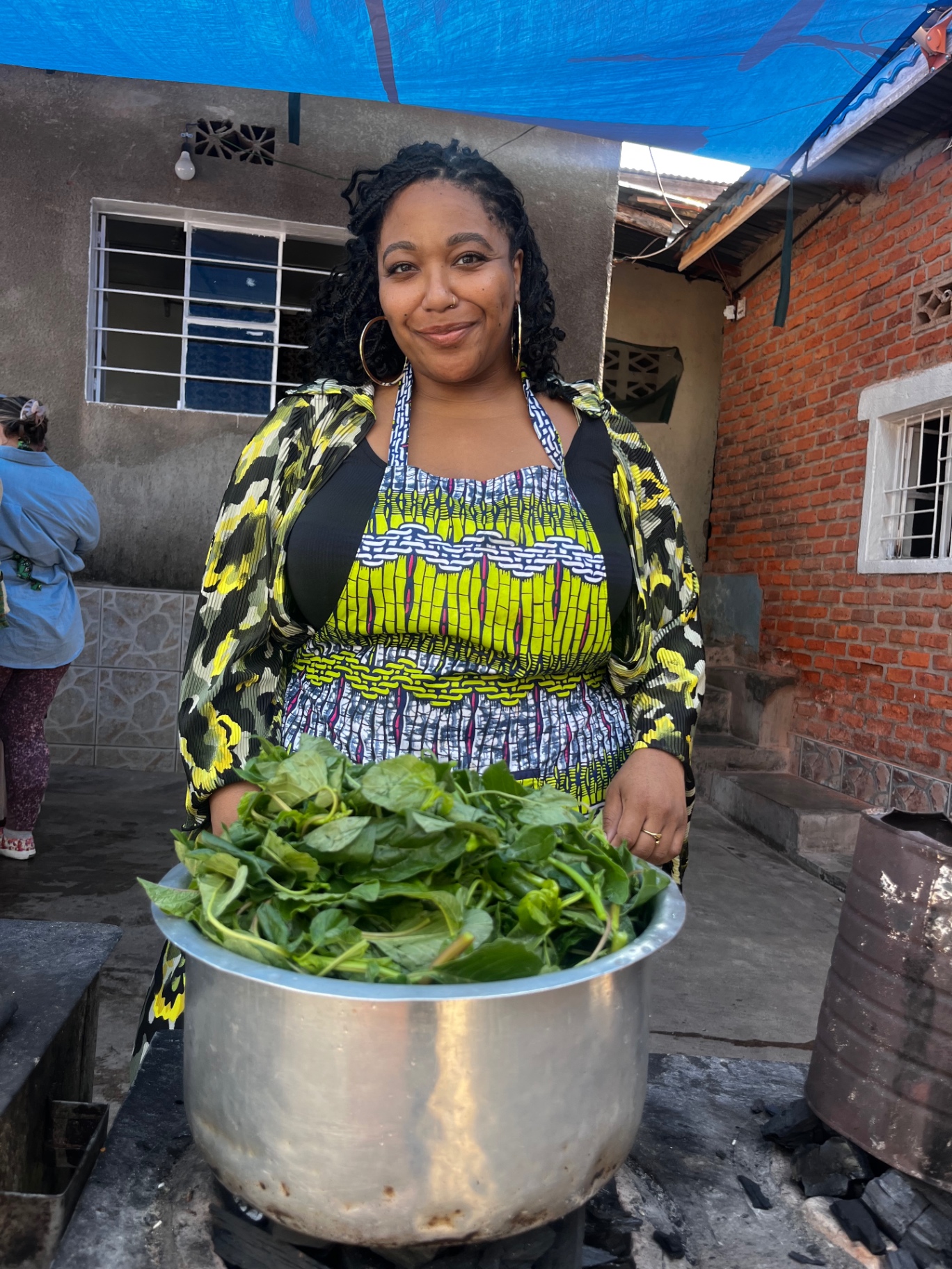 Chef Freda with fresh greens over open fire